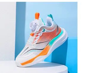 Detailed side view of kids mesh running shoe with orange accents and rotary dial