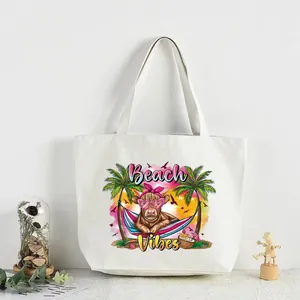 Summer beach vibes heat transfer sticker featuring a cow and palm trees on a tote bag