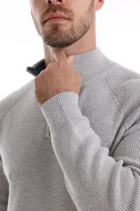 Detailed view of men's grey half-zip knitted sweater showing collar and cuff texture