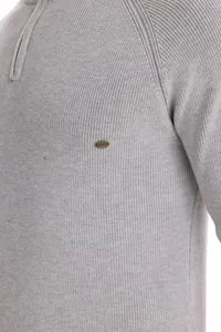 Close-up detail of men's grey half-zip ribbed knit sweater with AIOPESON logo plate