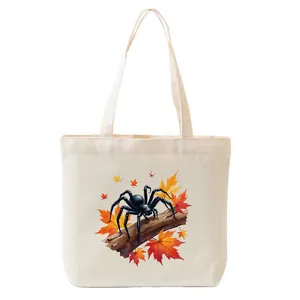 Close-up detail of Halloween spider and autumn maple leaves printed on a canvas tote bag