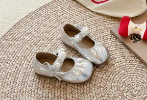 Vue détaillée des chaussures Mary Jane argentées pour filles avec bride en perles.