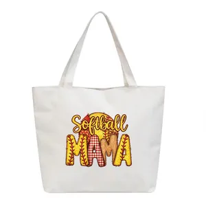 Close-up of "Softball MAMA" patchwork heat transfer print on white tote bag.