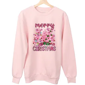 Close-up detail of a pink sweatshirt with a festive merry Christmas tree graphic