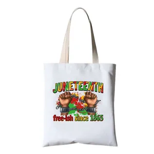 Close-up of Juneteenth free-ish since 1865 print on a durable white canvas tote bag