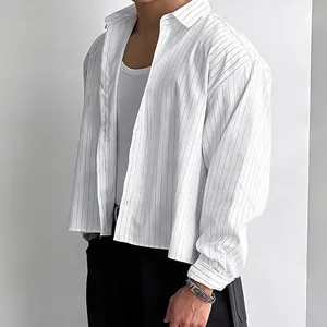 Close-up detail of a men's loose-fit striped long-sleeve shirt with a modern short-cut design