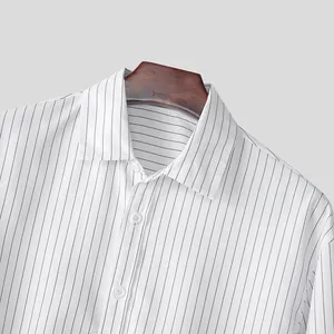 Close-up of men's white striped shirt collar and shoulder detail