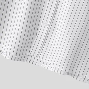 Close-up detail of white and black vertical striped shirt fabric and buttons.