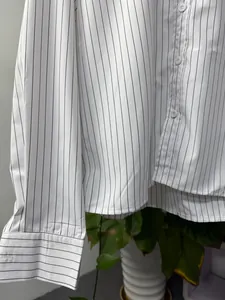 Close-up detail of a white vertical striped long-sleeve button-down shirt for men