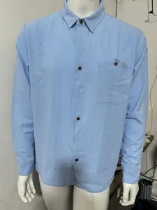 Close-up of a men's light blue linen long-sleeved shirt with a single chest pocket
