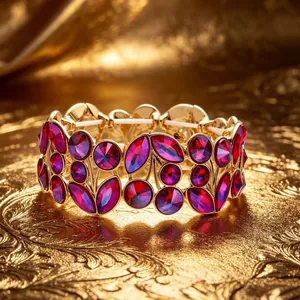 Detailed macro view of vintage gold bracelet with magenta crystals in leaf patterns