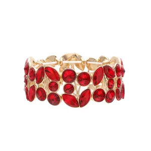 Close-up detail of vintage gold bracelet with faceted red leaf-shaped crystals
