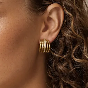 Detailansicht der goldenen mehrreihigen Creolen mit glitzernden Strasssteinen am Modellohr
