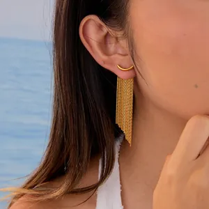 Detail of gold stainless steel curved bar earrings with multi-layer snake chain tassels
