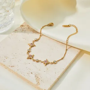 Detailed view of a gold-plated stainless steel bracelet with pink zircon stars.