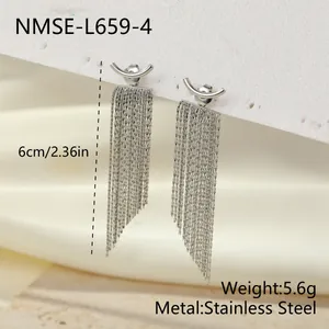 Detail of silver stainless steel arc earrings with multi-layered snake bone tassels