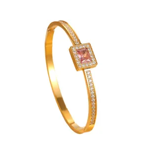 Elegant gold-plated stainless steel bangle featuring a rectangular pink zircon center.