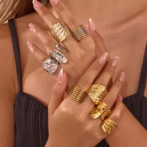 Detailed view of gold and silver stainless steel rings with hollow leaf texture