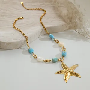 Detailed macro view of a gold ocean-style starfish pendant necklace with blue beads.