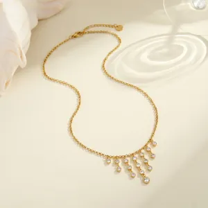 Detailed close-up of elegant gold fringe necklace with sparkling cubic zirconia