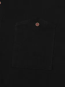 Macro view of breast pocket and decorative button on a black casual linen shirt for men
