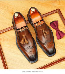 Close-up of premium men's brown leather brogue loafers with stylish tassel details