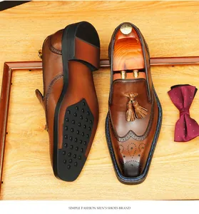 Macro detail of classic brown leather brogue loafers featuring tassels and square toe