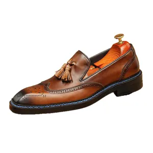 Classic men's brown leather tassel loafers with wingtip brogue detail and blue sole stitching