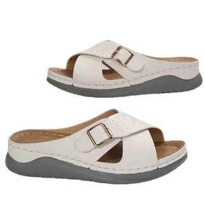 Elegant women's white wedge sandals featuring a cross strap design and metal buckle detail