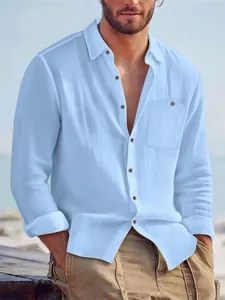 Detail of mens light blue long sleeve linen shirt with button-down collar and chest pocket.