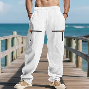 Vue détaillée du pantalon en lin blanc ample avec taille coulissante et poches zippées