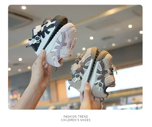 Close-up of baby walking shoes in black, pink, and brown colorways