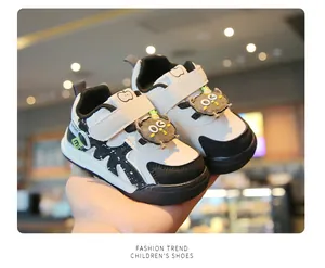 Detail view of toddler walking shoes with cute cartoon character decoration and velcro straps