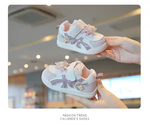 Close-up view of pink toddler walking shoes featuring soft soles and easy velcro straps