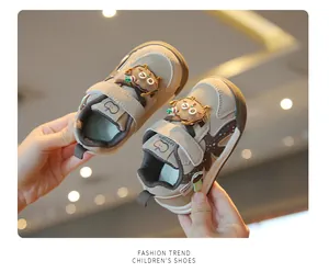 Detailed view of khaki toddler sneakers with cute cartoon bear decoration and secure straps