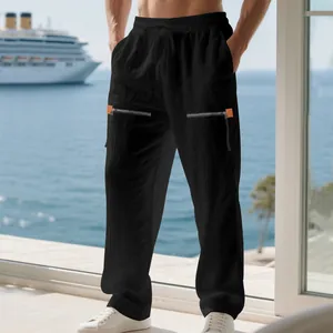 Détail de pantalon large en lin noir pour homme avec fermetures éclair sur la plage
