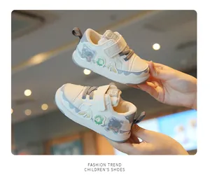 Detailed view of white toddler walking shoes with cute bear patches