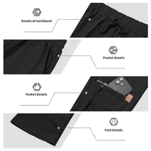 Vue détaillée de la taille à cordon et des poches zippées sur un pantalon noir décontracté