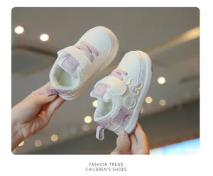 Detailed view of cream toddler walking shoes with cute purple bear patch