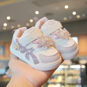 Cute pink and white toddler walking shoes featuring cartoon cookie charms and soft soles