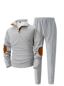 Detailed view of men's gray waffle knit tracksuit set featuring orange elbow patches.