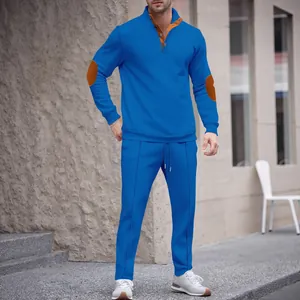 Full detail view of men's bright blue tracksuit with stand collar and brown elbow patches