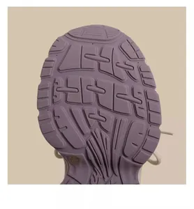 Detailed macro view of the anti-slip pattern on a purple children's sneaker outsole