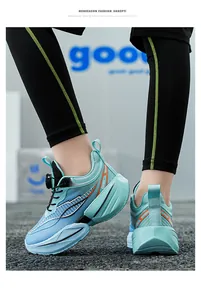 Side view of light blue boys' running shoe with orange accents and rotating dial