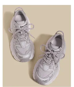 Detail view of grey children's chunky sneakers with metallic overlays and mesh panels.