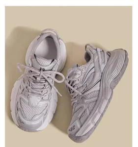 Minimalist close-up of breathable mesh dad sneakers for children in elegant beige color.