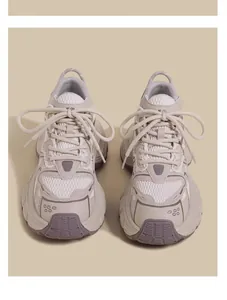Symmetrical front view of breathable kids' mesh chunky sneakers in off-white and grey