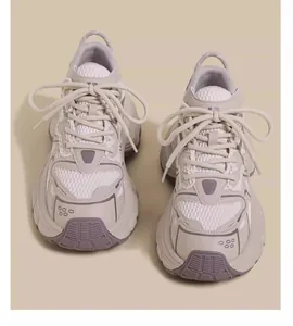 A detailed front view of breathable grey mesh chunky sneakers for kids and teenagers