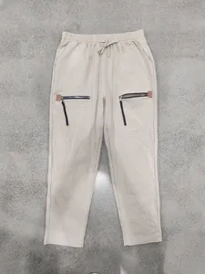 Pantalon en lin beige coupe ample avec fermetures éclair et cordon de serrage taille