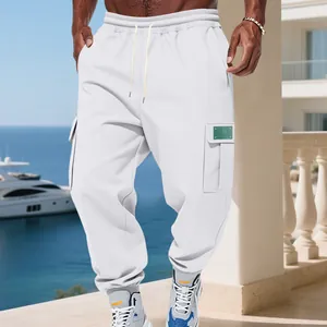 Detail of white fleece-lined cargo joggers featuring side pockets and tapered elastic cuffs